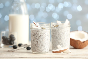 Tasty chia seed pudding with on table against blurred background