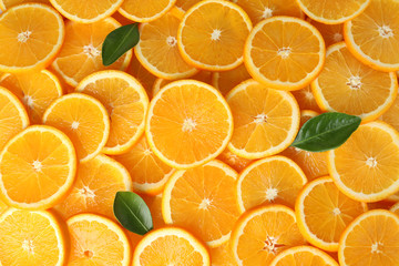Many sliced fresh ripe oranges as background, top view