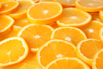 Many sliced fresh ripe oranges as background, closeup