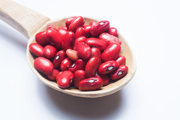 red beans on wooden spoon