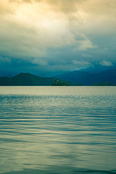 Beautiful liniar view of water mountains and sky on a foggy day
