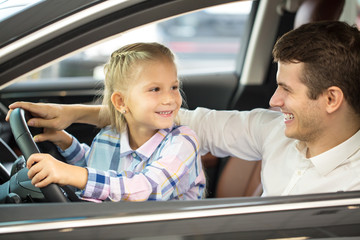 Young man and his daughter in a car