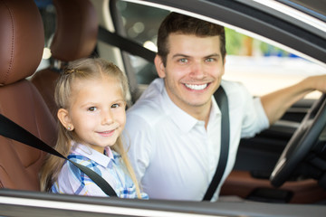 Young man and his daughter in a car