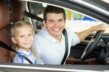 Young man and his daughter in a car