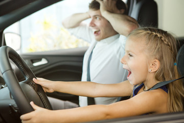 Young man and his daughter in a car