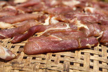 Red meat on wooden basket.