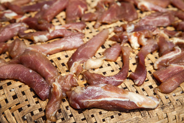 Red meat on wooden basket.