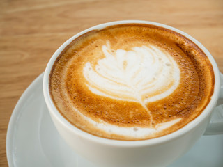 Cup of latte art coffee in the coffee shop