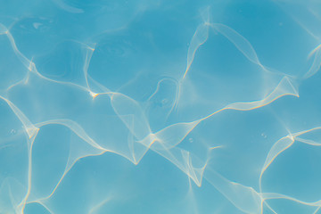 Blue pool water with sun reflections