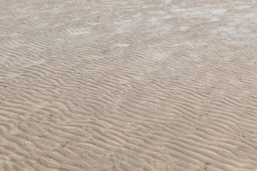 Naklejka na ściany i meble Yellow wave sand texture on the beach