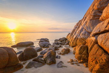 Fototapeta na wymiar Sea sunset rocks beach on blue sky background. Beauty evening sunrise. Blue background. wonderful landscape