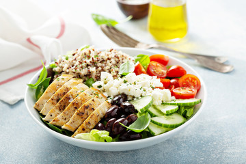 Greek inspired lunch bowl with chicken, quinoa, feta cheese and olives