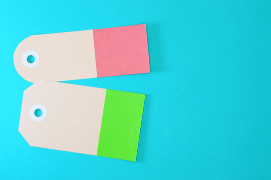 green and orange rectangle paper tags on blue background