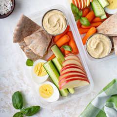 Healthy and nutricious lunch or snack boxes to go with hummus and pita, eggs and vegetables