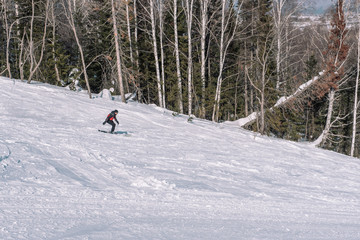 A skier rides down the mountain. Winter sport. Dangerous sport. Winter landscape. Winter in Siberia. To ski.