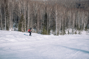 A skier rides down the mountain. Winter sport. Dangerous sport. Winter landscape. Winter in Siberia. To ski.