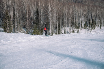 A skier rides down the mountain. Winter sport. Dangerous sport. Winter landscape. Winter in Siberia. To ski.