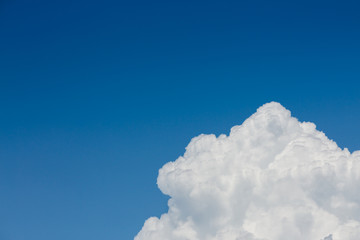 fluffy white cloud above clear blue sky background
