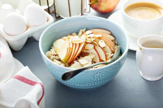 Healthy oatmeal with sliced apple and almonds for breakfast