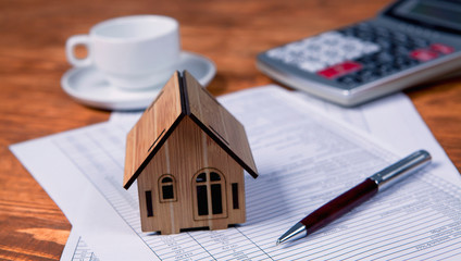 house, calculator and documents