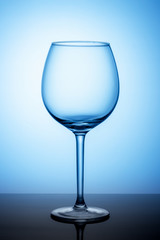 empty wine glass on blue background