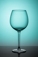 empty wine glass on green background