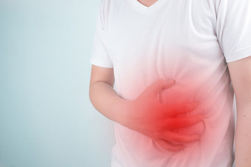 Asian Young men are suffering from stomach ulcers. gastritis Caused by the infection of H. pylori bacteria  healthcare and health problem concept