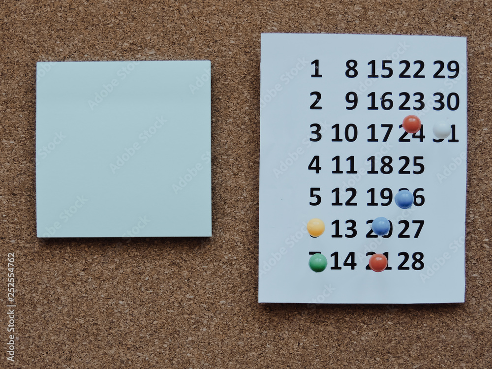 Fototapete planning a project-close up.thumbtack in calendar concept for busy,work space.business meeting sched
