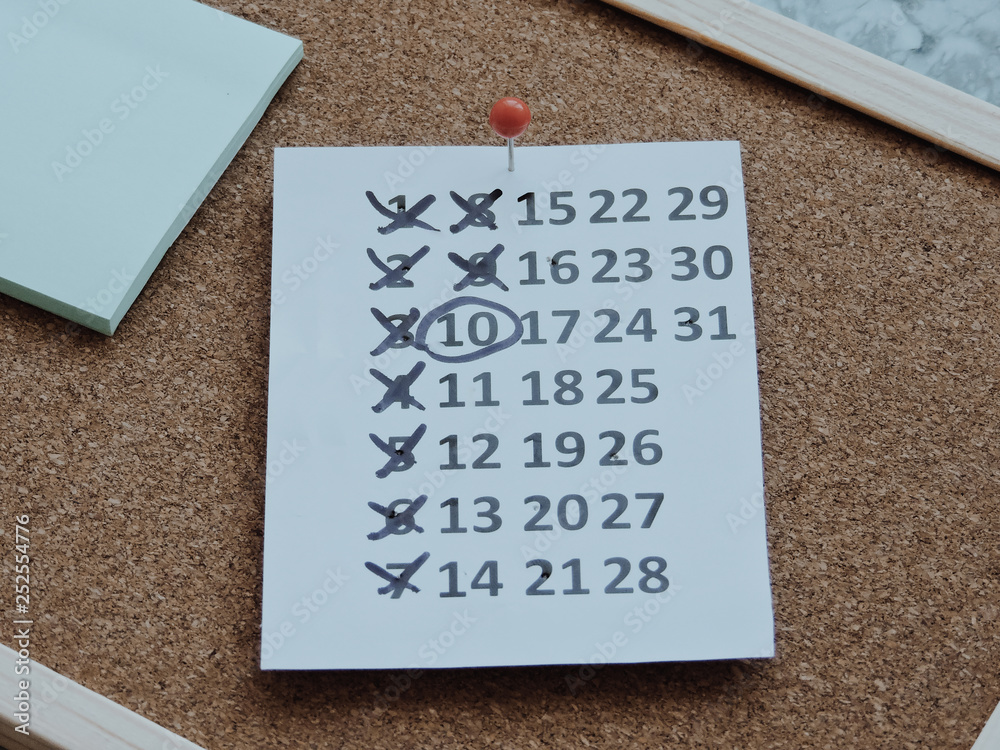 Fototapete planning a project-close up.thumbtack in calendar concept for busy,work space.business meeting sched