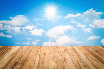 wood table and blue sky with sun background