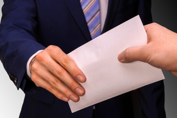 A man who conceals his identity transfers the money in an envelope. Concept on the theme of...