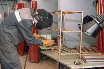 The welder makes the part. Worker welds the details. Master of semi-automatic welding.