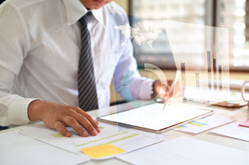 Businessman working with analysis data on digital tablet.