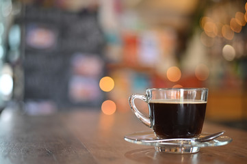 Coffee cup on wood table in cafe.