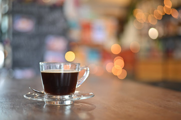Coffee cup on wood table in cafe.