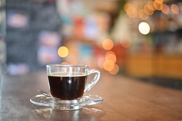 Coffee cup on wood table in cafe.