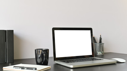 Office workspace computer, coffee and office supply on black table selective focus.
