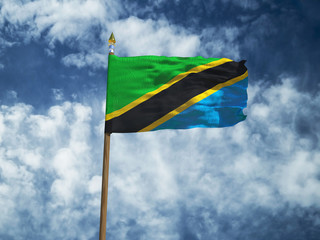 Tanzania flag Silk waving flag of Tanzania made transparent fabric with wooden flagpole gold spear on background sunny blue sky white smoke clouds real retro photo Countries of world 3d illustration