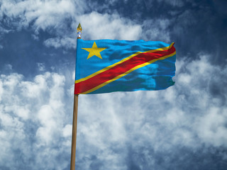 Democratic Republic of the Congo flag Silk waving flag of DR Congo made transparent fabric with wooden flagpole gold spear on background blue sky white smoke clouds real retro photo 3d illustration