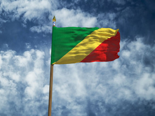 Republic of the Congo flag Silk waving flag of Congo Republic made transparent fabric with wooden flagpole gold spear on background sunny blue sky white smoke clouds real retro photo 3d illustration
