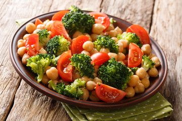 Vegetable salad from broccoli, chickpeas and fresh tomatoes with olive oil close-up. horizontal