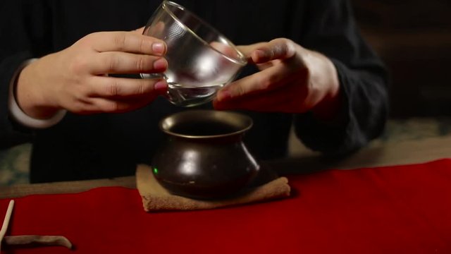 a man prepares tea according to a traditional recipe matcha