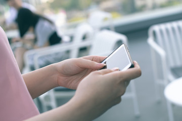girl use mobile phone for social network internet business with ther people on background with chair