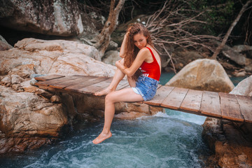  girl in a swimsuit at a waterfall