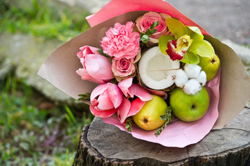 Edible bouquet. Fresh bouquet with fruits and flowers. Creative bouquet for the wedding.