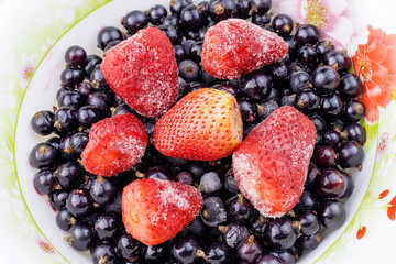 Close up of frozen mixed fruit - berries - black currant, strawberry