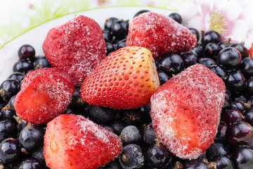Close up of frozen mixed fruit - berries - black currant, strawberry