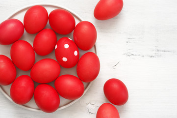 Red Easter eggs in plate