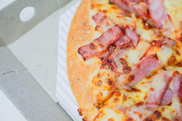 Close up of hawaiian pizza with boiled ham and pineapple.