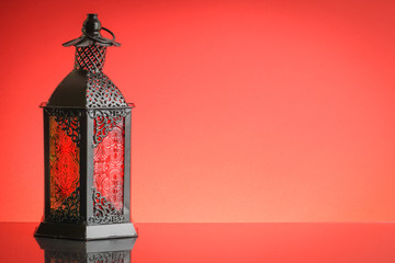 Ramadan lantern or Arabic decoration lamp on red background. Selective focus